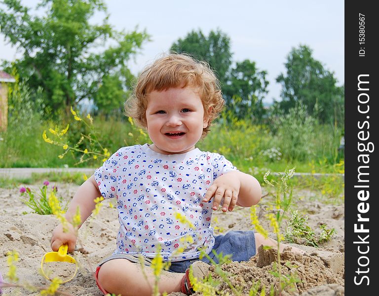 Baby playing on the sand