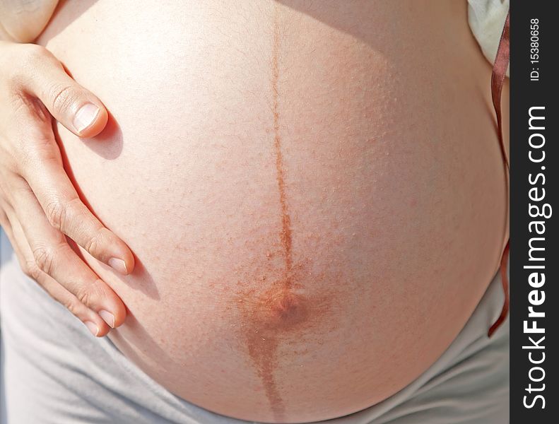 Pregnant woman and exposed belly