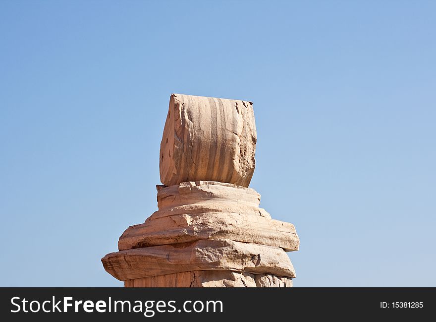 Ruins of a column on a sky background