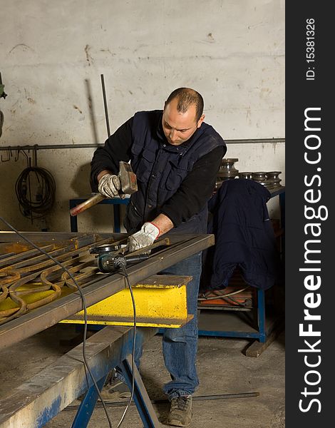 Metalworkers while working in a workshop in a site