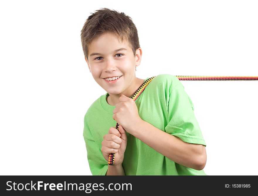 Boy pulling a rope -with the rope on his shoulder- isolated on white