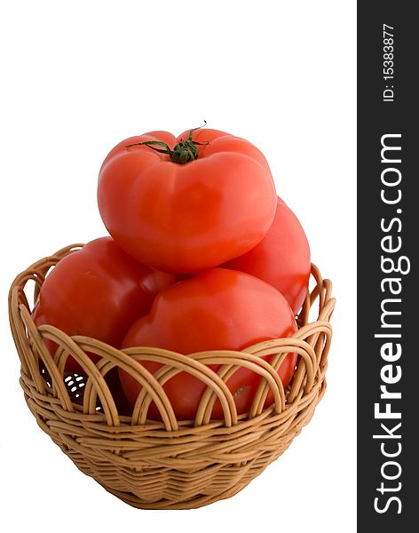 Red tomatoes with a wooden basket. Red tomatoes with a wooden basket