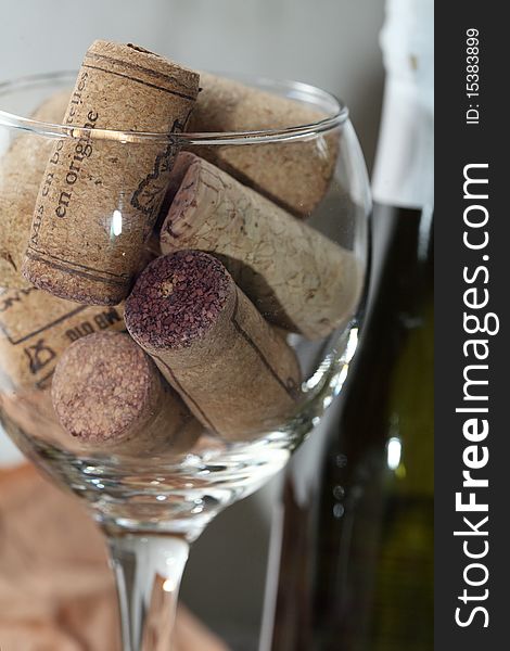 Image of a wine glass full of corks