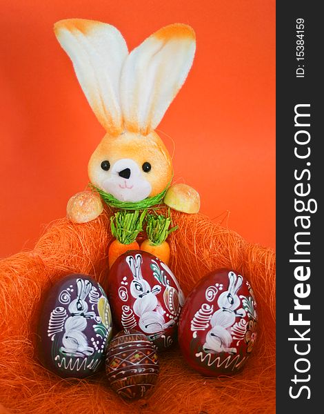 Easter Bunny with easter eggs in an orange composition