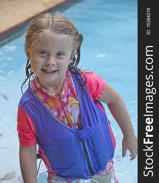 Photo image of a happy little girl in a swimming pool. Photo image of a happy little girl in a swimming pool