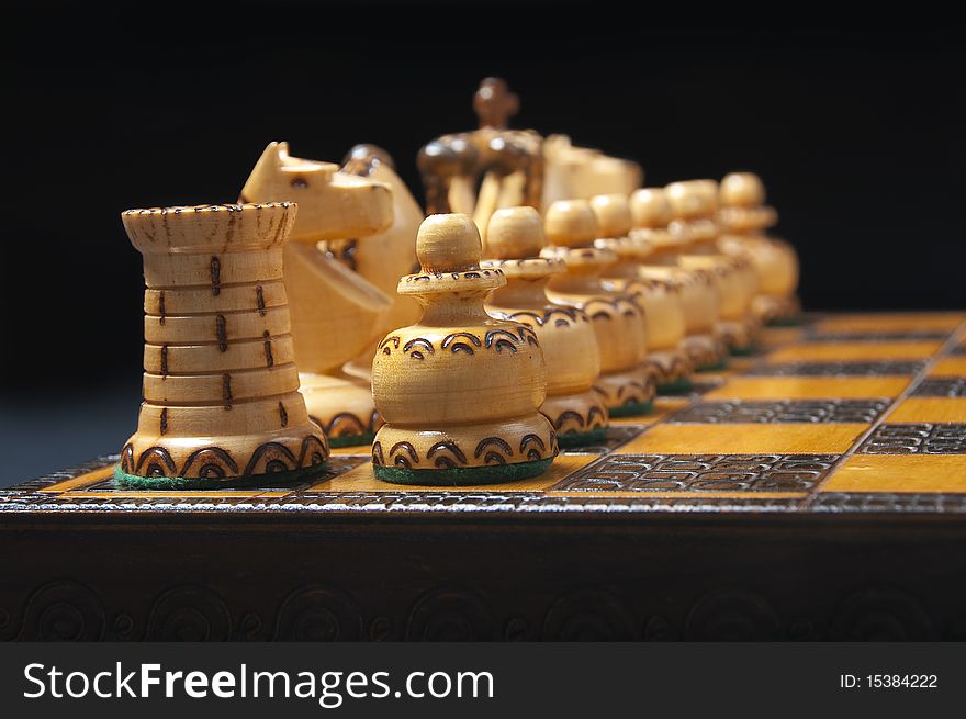 Beautifully carved white chess figures standing on the chessboard.