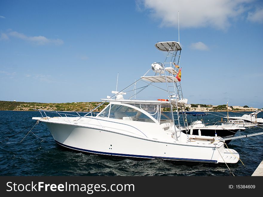 A horizontal image of a speedboat with a high observation platform