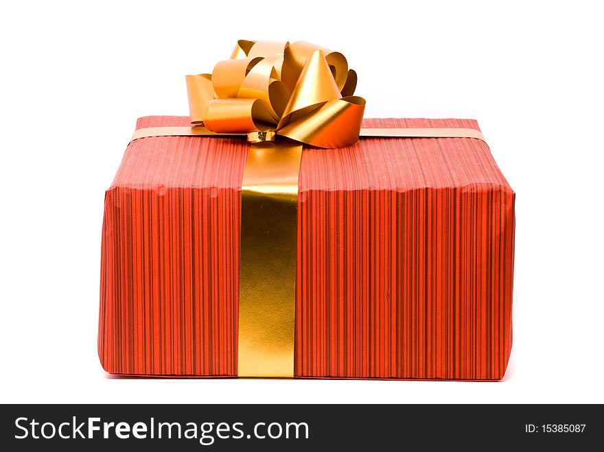 Red gift box with golden bow on a white background