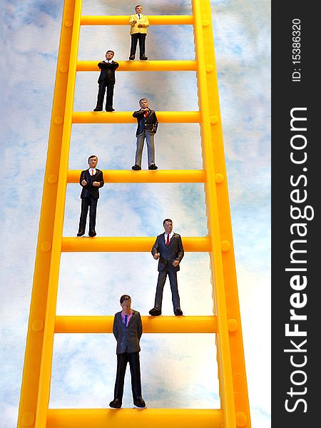 Figurines of business men on a ladder. Figurines of business men on a ladder