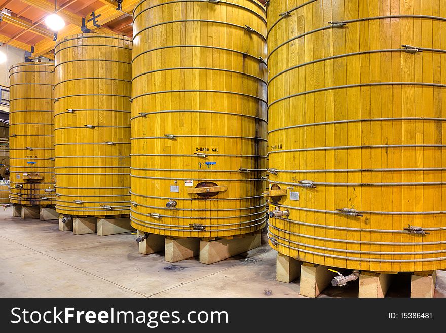 Large wooden casks in a California winery cellar. Large wooden casks in a California winery cellar.