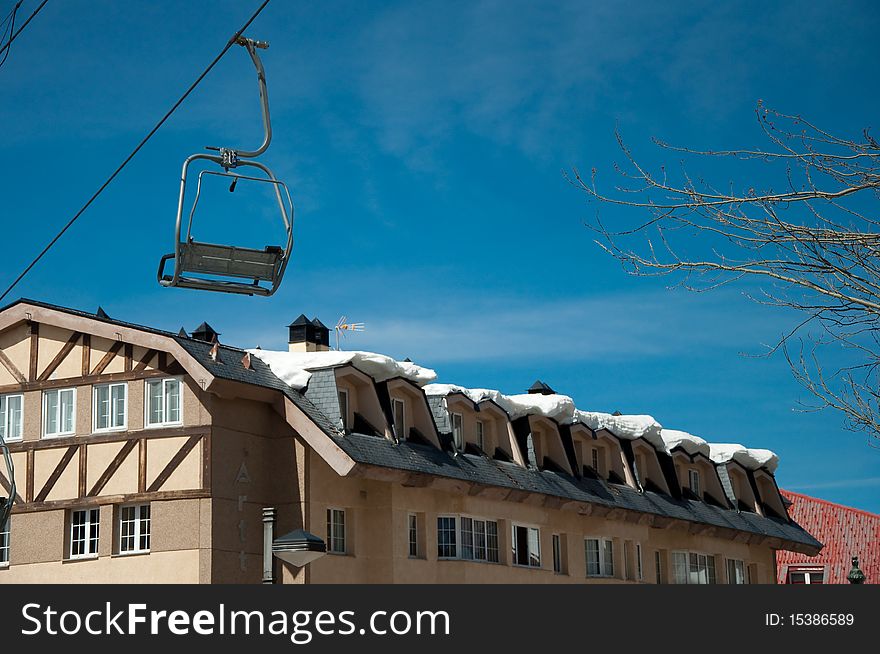 Lift to climb the Mountain with houses snowy