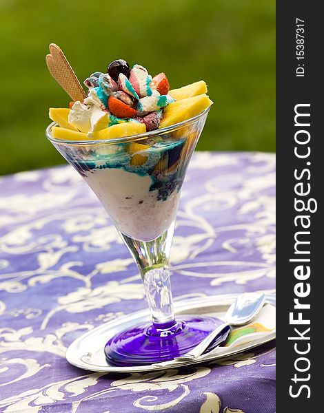 Big Ice cream in glass bowl on green background .