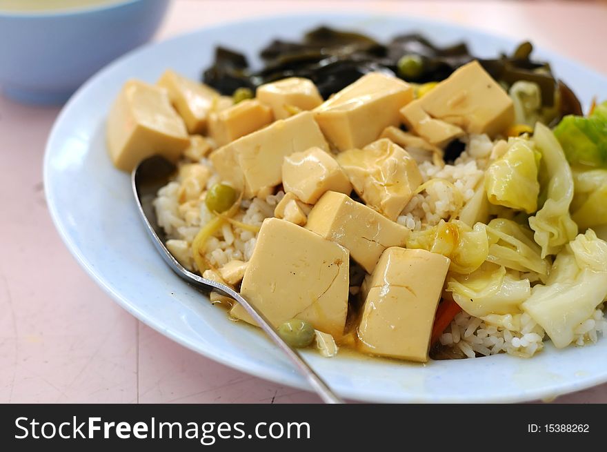 Chinese vegetarian bean curd cuisine served with rice. Ingredients include bean curd and mushrooms. Suitable for food and beverage, healthy eating and lifestyle, and diet and nutrition.