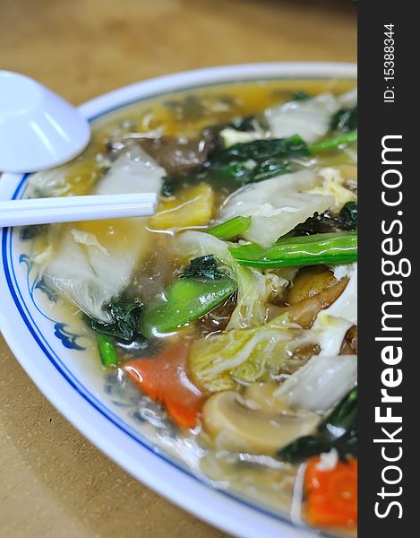 Chinese fried kway teow with healthy vegetables. Suitable for concepts such as diet and nutrition, healthy lifestyle, and food and beverage. Chinese fried kway teow with healthy vegetables. Suitable for concepts such as diet and nutrition, healthy lifestyle, and food and beverage.
