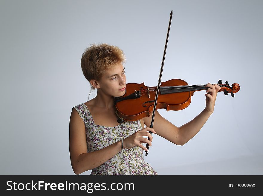 Girl in a tank topped dress with a violin. Girl in a tank topped dress with a violin.