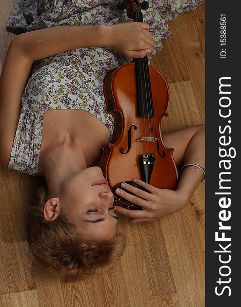 Girl in a tank topped dress with a violin. Girl in a tank topped dress with a violin.