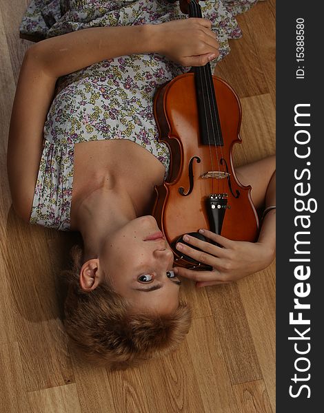 Girl in a tank topped flower sun dress with a violin. Girl in a tank topped flower sun dress with a violin.