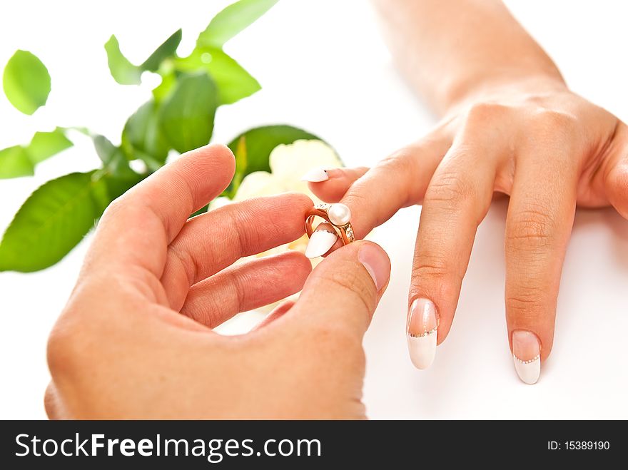 Man's and woman's hands with golden ring on white background. Man's and woman's hands with golden ring on white background