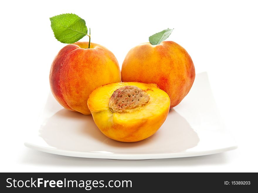 Three peaches on a white background.