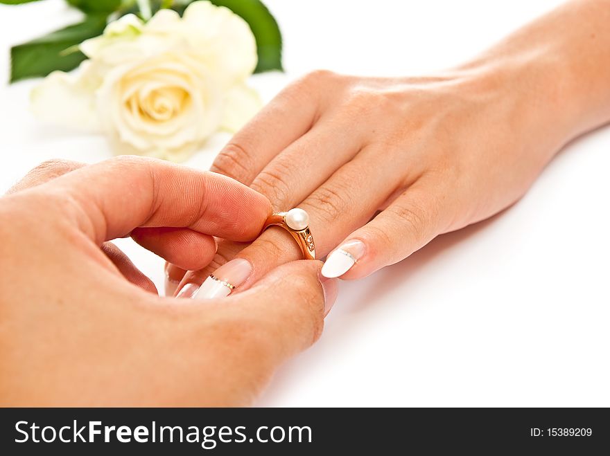 Man's and woman's hands with golden ring. White background. Man's and woman's hands with golden ring. White background