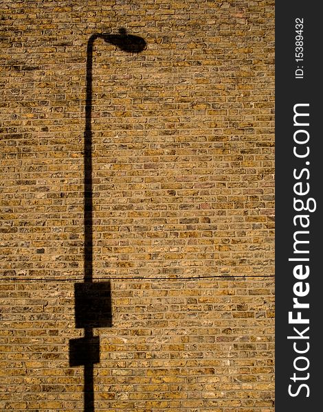 Lamp Post Shadow On Brick Wall