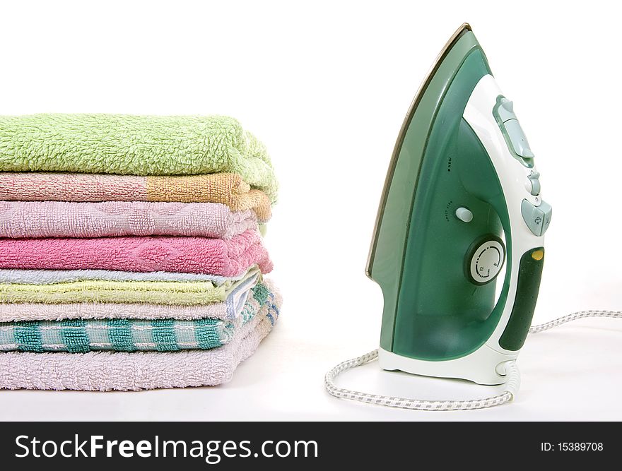 Iron and towels on a white background