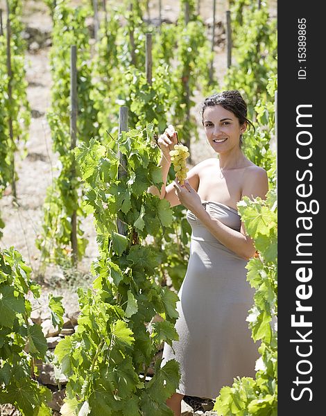 Woman with grapes in a vineyard