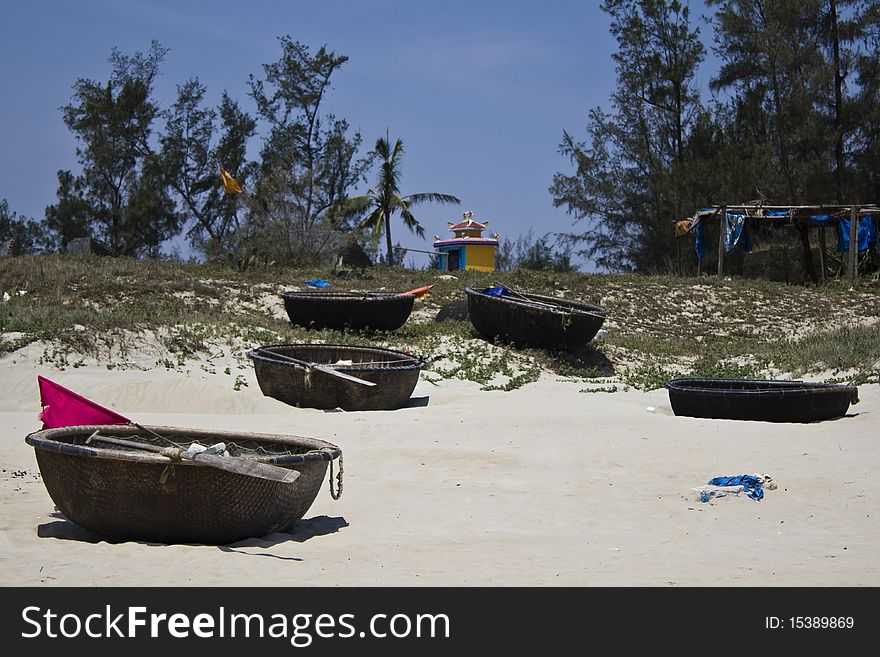 Traditional Vietnamese woven basket boats on a sandy beach. Traditional Vietnamese woven basket boats on a sandy beach.