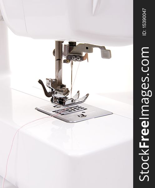 Electric sewing machine on a white background
