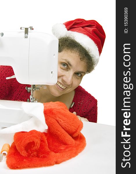 Woman sewing a fur coat for Santa Claus