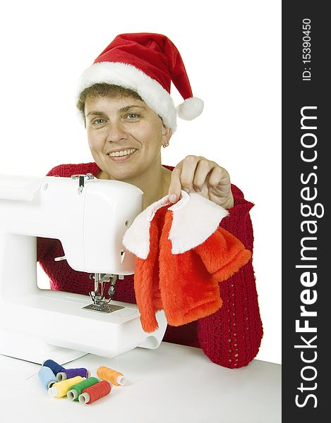 Woman sewing a fur coat for Santa Claus