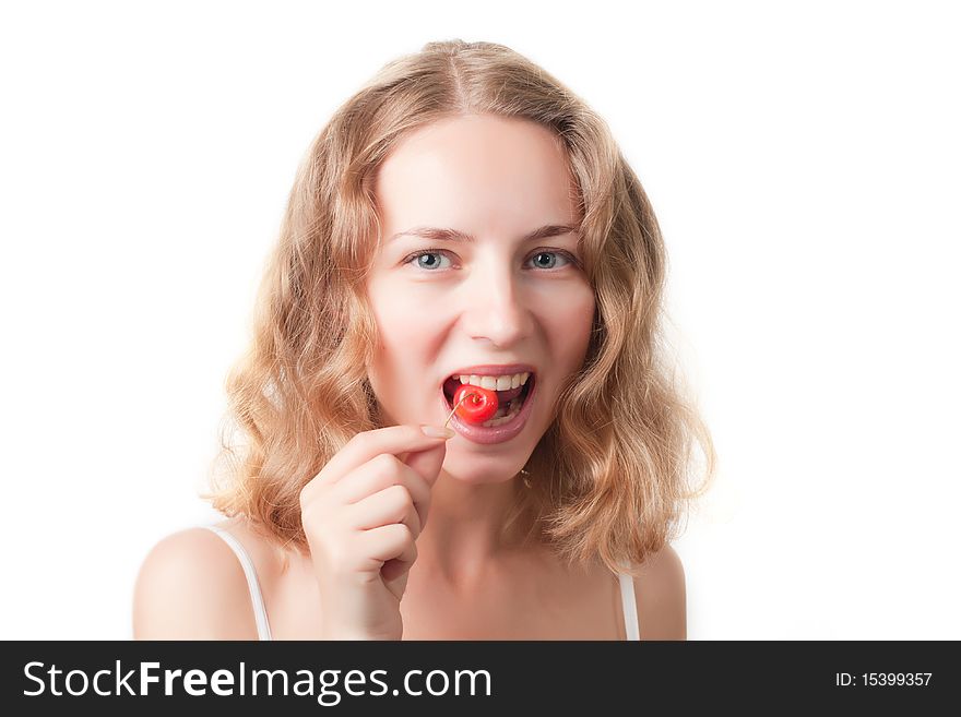 Beautiful young woman with cherries in the mouth isolated on a white background