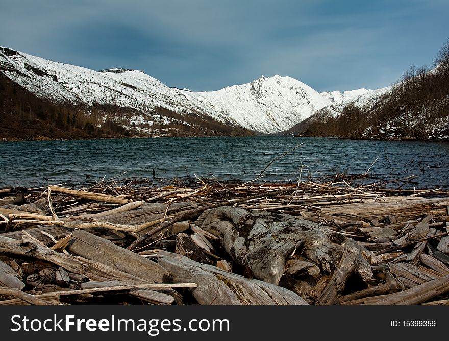 Clear water lake in front of a snowy mountain