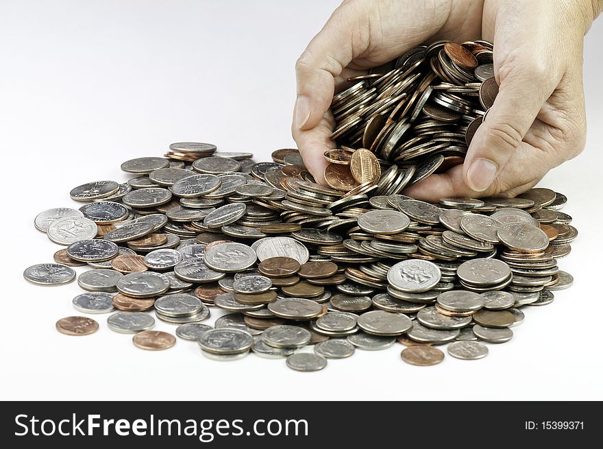 Hands grabbing a variety of American coins. Hands grabbing a variety of American coins
