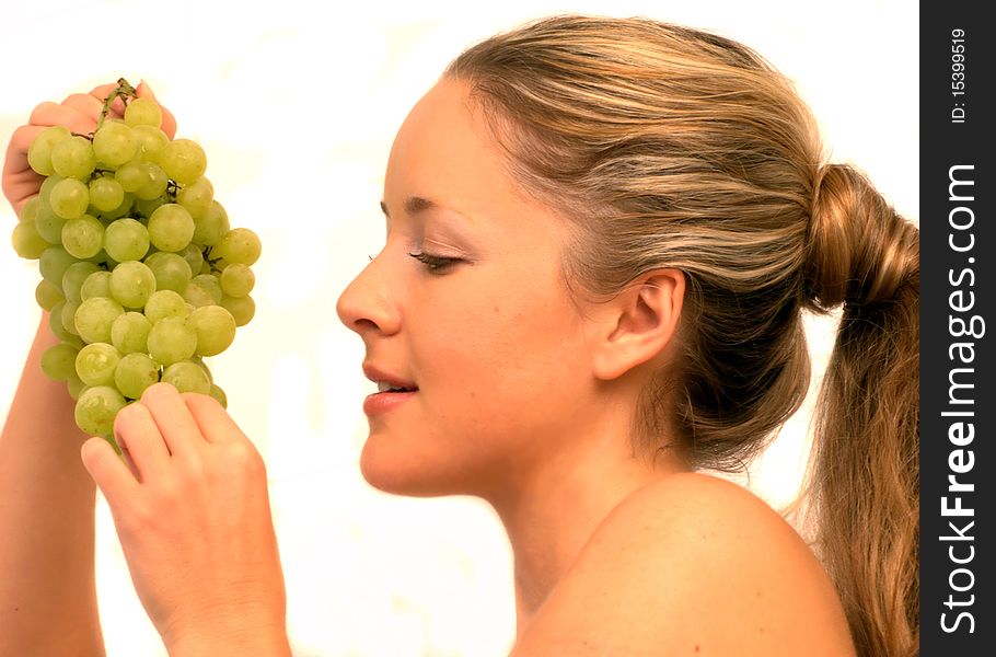 Young woman holding a bunch of grapes. Young woman holding a bunch of grapes