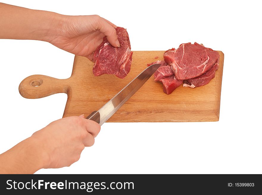 Slices of the meat on the board with knife on the kitchen