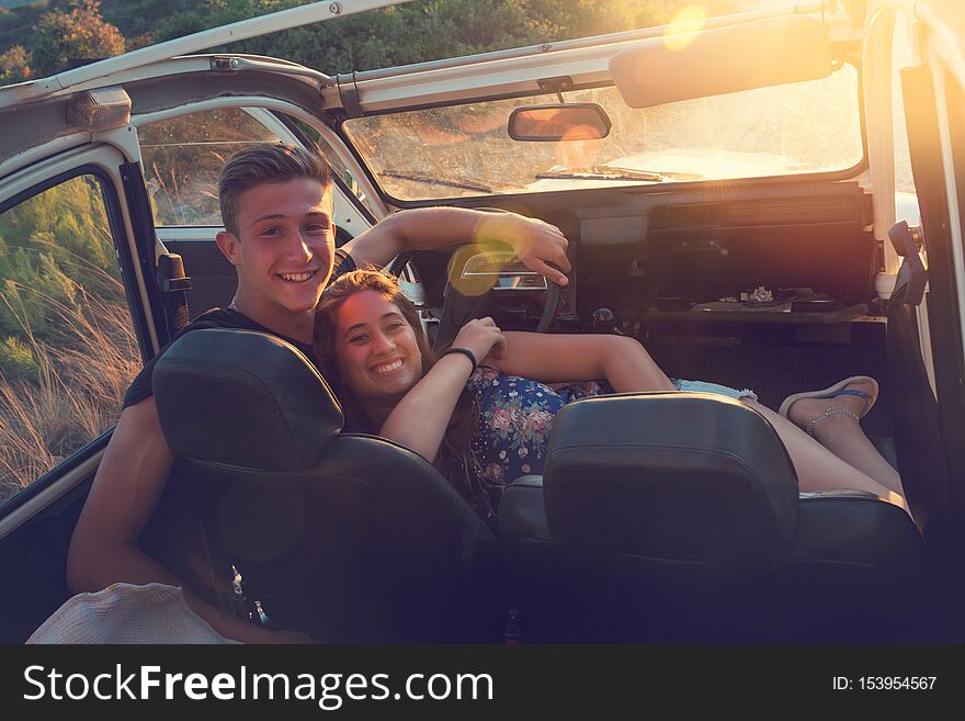 Group of happy people in a car at sunset in summer. Group of happy people in a car at sunset in summer