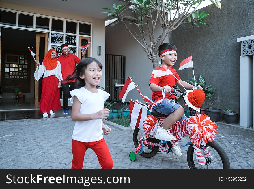 Children having fun in indonesia independence day celebration playing with their decorated bicycle. Children having fun in indonesia independence day celebration playing with their decorated bicycle