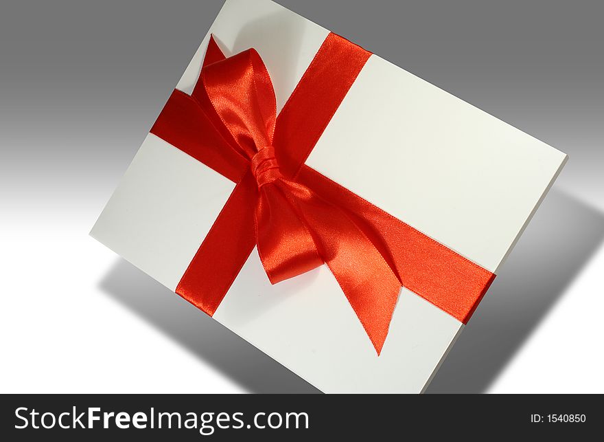 Blank white gift covered with red ribbon. Blank white gift covered with red ribbon