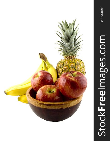 Wooden bowl with four red apples, a bunch of yellow bananas and a pineapple. Wooden bowl with four red apples, a bunch of yellow bananas and a pineapple