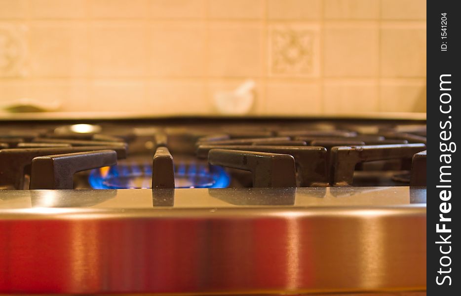 Kitchen burner with the blue flame turned on