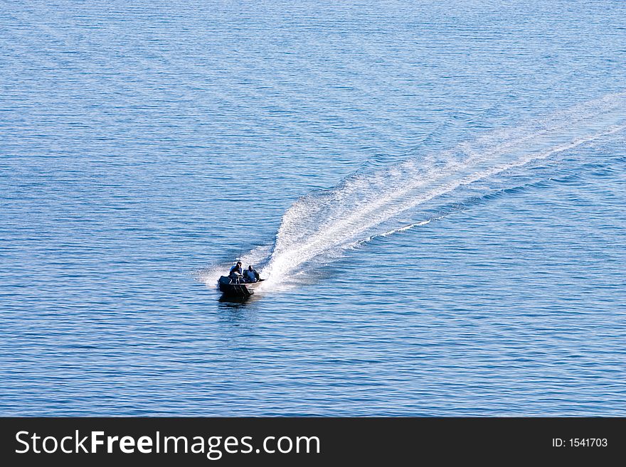 Small Boat traveling across calm water. Small Boat traveling across calm water