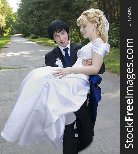 Young bride and groom at walking on after wedding ceremony