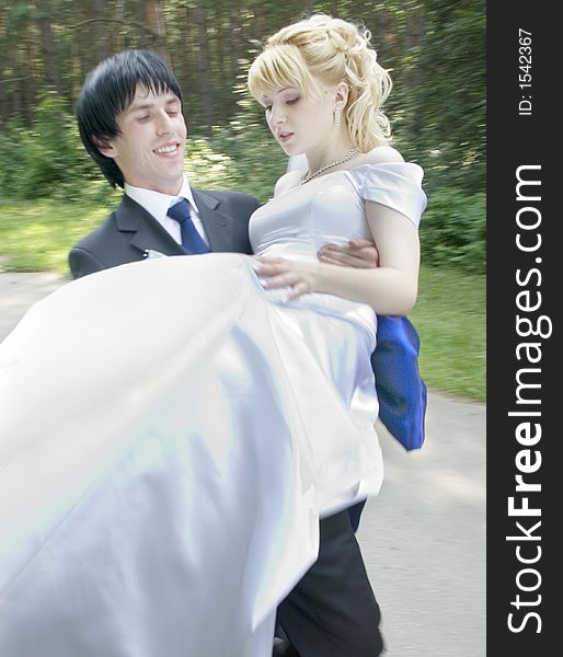 Young bride and groom at walking on after wedding ceremony