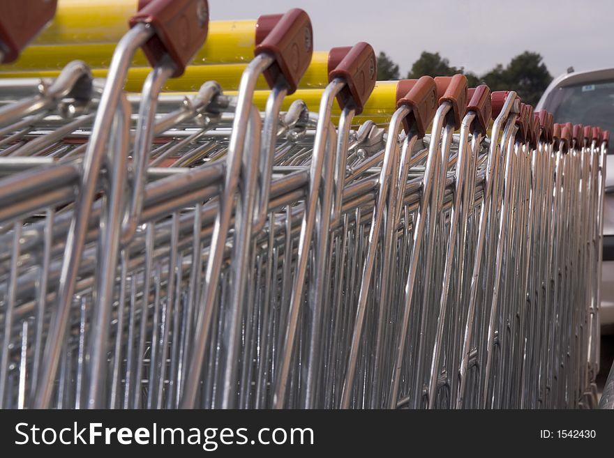 A group of parked shopping carts in a mall