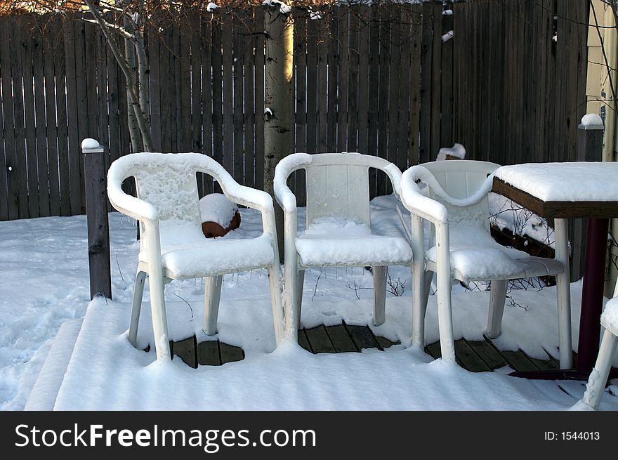 Plastic Summer Chairs in Winter with Snow
