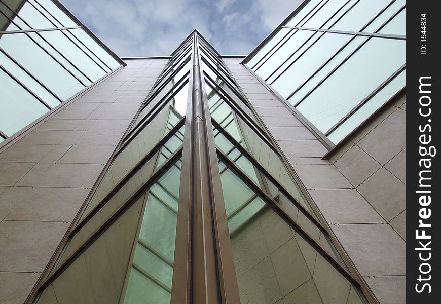 A fragment of a building, with a ledge of the triangular form, on a background of the sky. A fragment of a building, with a ledge of the triangular form, on a background of the sky.