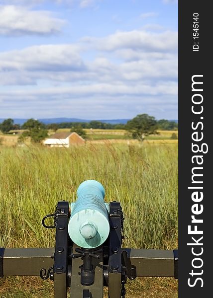Civil War cannon is aimed out over the fields of the Gettysburg Battlefield in Gettysburg Pennsylvania. Civil War cannon is aimed out over the fields of the Gettysburg Battlefield in Gettysburg Pennsylvania
