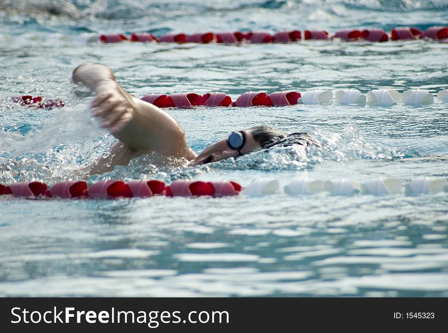 A man swimming in a pool. A man swimming in a pool