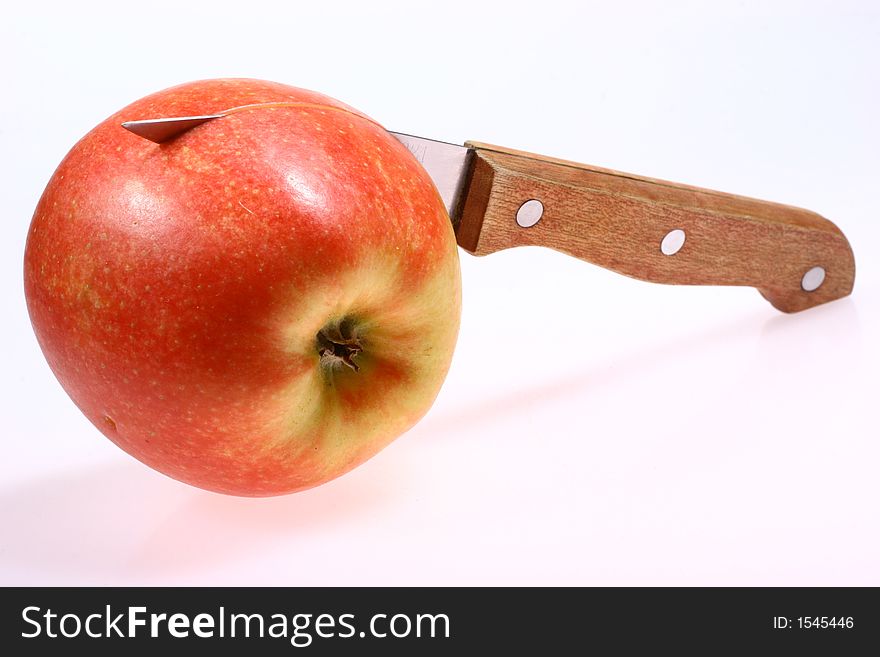 Red apple and knife isolated on white